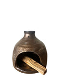 gold palo santo burner on white background 