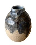 Ceramic vase with blue and brown glaze on a white background