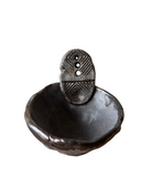 Decorative metal hook with a bowl-like base on a white background