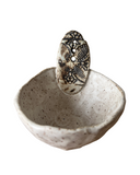 Ceramic herb bowl with a decorative tab on a white background