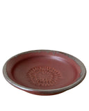 Ceramic dish with decorative pattern on a white background