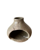 A green palo santo burner on a white background. 