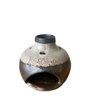 Gold and beige palo santo incense burner on white background 