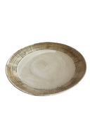 Round ceramic plate with textured rim on a white background