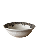 Ceramic bowl with a textured surface on a white background