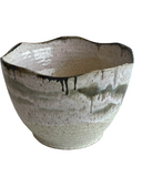 Ceramic bowl with textured surface on a white background