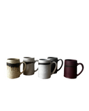 Set of five ceramic mugs with different color designs on a white background