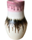 Ceramic vase with pink and brown drip glaze on a white background