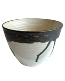 Ceramic bowl with black and white design on a white background