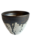 Ceramic bowl with black and white design on a white background