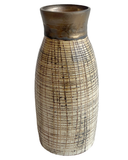 Decorative vase with textured surface on a white background