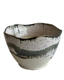 Ceramic bowl with textured surface on a white background