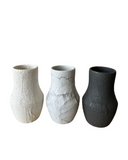 Three textured ceramic vases on a white background
