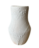 A textured ceramic vase with a bulbous shape, featuring a rough, bubbled stoneware finish in a warm off-white color, isolated on a white background.