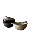 Set of ceramic bowls with chopsticks on a white background
