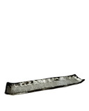 Long, narrow black rectangular plate with decorative patterns on a white background