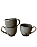 Gray and black mugs on white background