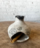 Speckled palo santo burner chimenea with floral patterns on a wooden surface