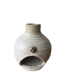 white and beige chiminea for palo santo on white background 