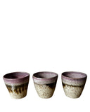 Three ceramic cups with a purple and beige gradient on a white background