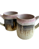 A set of pink mugs on a white background. 