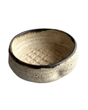 Ceramic bowl with textured surface on a white background