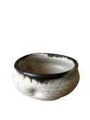 Stack of handcrafted ceramic pinch bowls in black, white, and brown colors