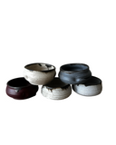 Group of ceramic dip bowls on a white background