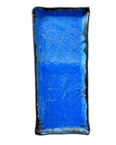 Rectangular blue ceramic plate with black rim on a white background