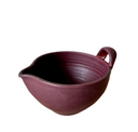 A beige ceramic batter bowl with a speckled pattern and bronze accent at the lip, crafted from brown stoneware clay.