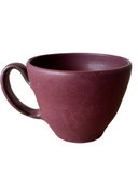 A red cappuccino mug on a white background