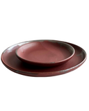Stack of red plates on white background