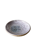 Ceramic plate with decorative patterns on a white background