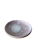 Ceramic plate with decorative patterns on a white background