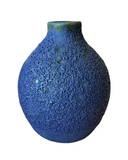Blue textured vase on a white background