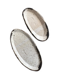 Two oval-shaped ceramic trays with a speckled beige and white glaze finish. One is small and the other is medium-sized.