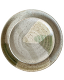 A ceramic side plate with a satin avocado green glaze, featuring brown stoneware clay with speckles.