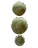 Three ceramic bowls of varying sizes on a white background