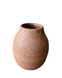A warm pink with hints of beige porcelain vase with a frothy, bubbly glaze.