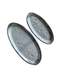 Two oval-shaped ceramic trays with a speckled beige and white glaze finish. One is small and the other is medium-sized.