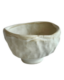 Ceramic bowl with a textured surface on a white background