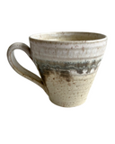 Ceramic mug with a textured surface on a white background