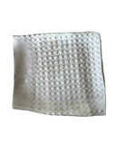 Textured white towel with circular patterns on a white background