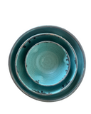 Set of two turquoise ceramic bowls on a white background