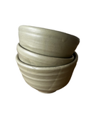 Set of three stacked ceramic bowls on a white background