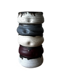 Stacked ceramic vases with gradient colors on a white background