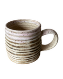 Speckled ceramic mug on a white background