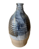 Ceramic vase with blue and beige glaze on a white background