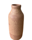 A warm pink with hints of beige porcelain vase with a frothy, bubbly glaze.