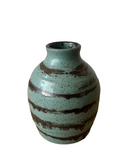 Green ceramic vase with brown stripes on a white background